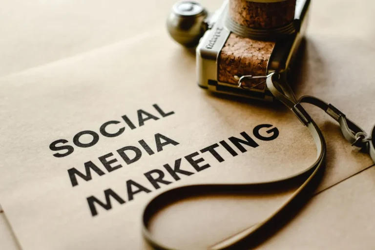 Close-up of a camera placed on brown paper with 'Social Media Marketing' text, emphasizing digital marketing themes.
